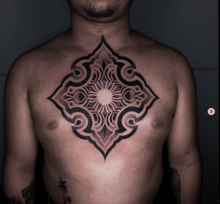 Large moth chest tattoo